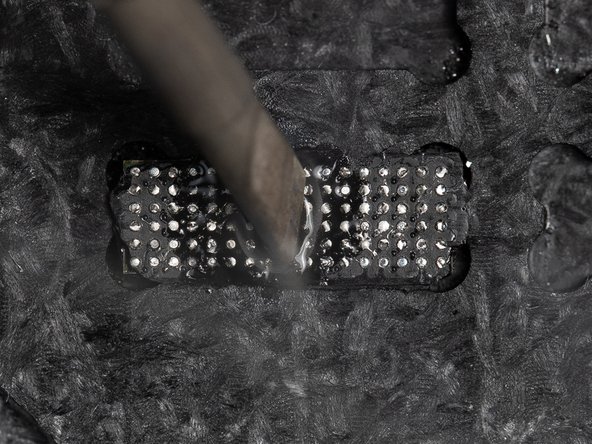 Set your soldering iron to 400°C and place it in the centre of the IC chip.