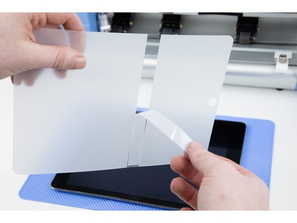 Your film will have a sticky allignment layer you'll need to peel off. This will help you stick the film down in the correct location.