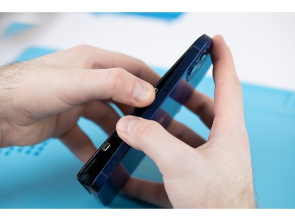 Once most of your screen has come loose, remove your suction cup and begin prying the screen off with your hands. With a small amount of force, the screen should come free from the adhesive. Your phone should open like a book.