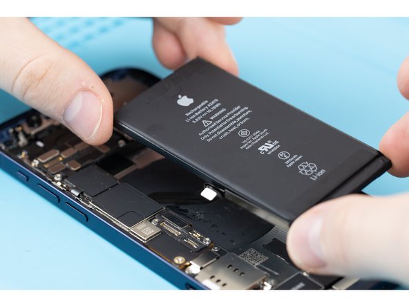 Carefully position the battery and place it into the phone.