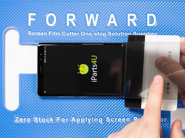 With your application tool slowly slide it along the film until you reach the top of the phone.