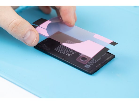 Grab your new battery, line up the adhesives and slowly stick them down to the back  side of the battery.