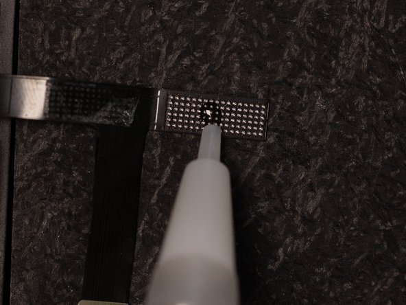 Using the Tesa that you just applied, stick the flex to a reballing base or any flat surface that will withstand high temperatures &amp; that the Tesa will stick to.