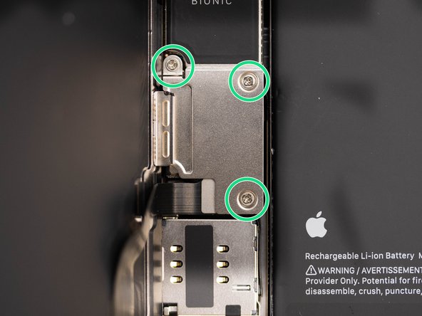 There are three screws holding the battery and display connector cover down. You'll need to remove these.