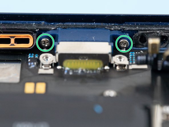 Remove the two screws holding the charge port to the bottom of the iPhone case.