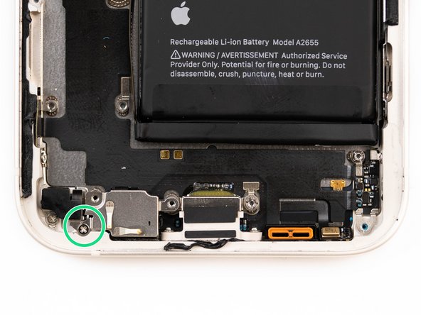 There's a protective cover resting over two microphones. Remove the screw securing the protective cover.