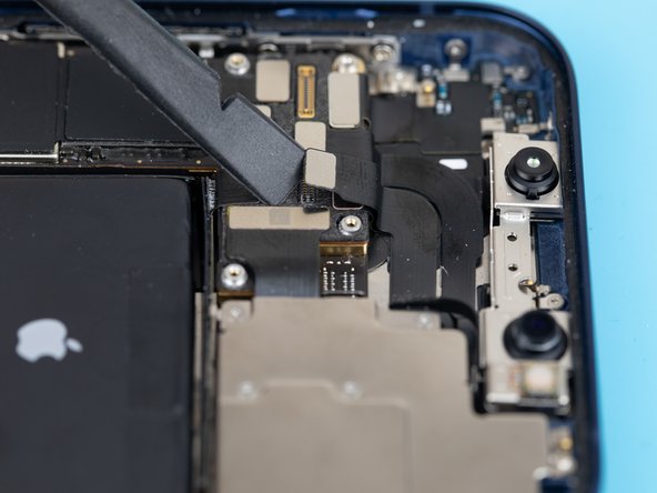 Using a spudger or your fingernail, lift the dot projector flex out from its resting socket on the logic board.