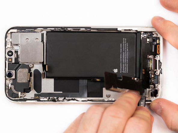 Apply a small amount of IPA to loosen the charge port. This will help you lift it up from the phone case.