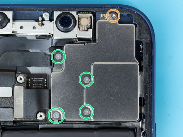 The rear-facing camera is secured with five screws and a protective cover. Remove the five screws.