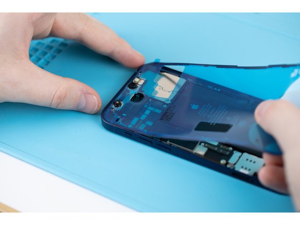 Line up the adhesive with the top edge of your iPhone case and gently press it into place. Do the same with the opposite side of the adhesive.