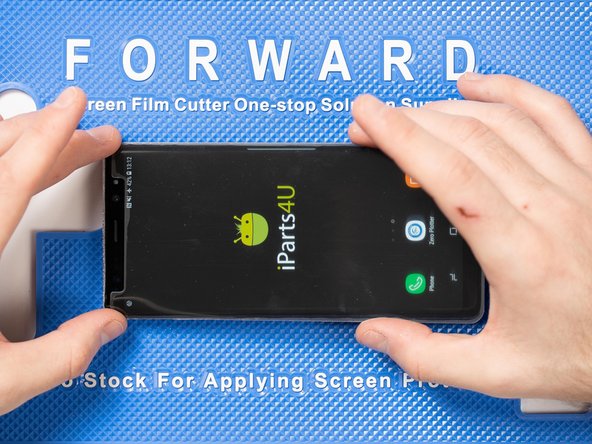 Lower the front film onto the front of the phone. We find it's easiest to lower the top end of the film first.