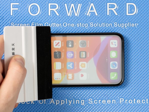 As you lower the film down onto the phone into the correct position, Use an application tool or brush your finger across the entire strip to help it attach to the phone.