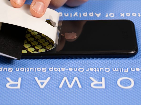 Hold the top of the film down with an application tool to avoid peeling it off.