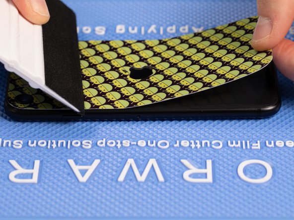 Starting at the bottom of the film towards the charge port, lift the film up with your fingers and peel it backwards.