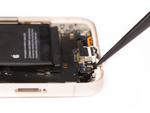 Using a tweezer, disconnect the first microphone from its socket.