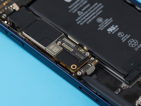 Using your fingers, gently fold back the flex cables at the top of the motherboard. You can now safely remove the motherboard.