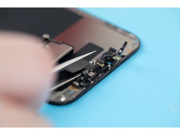 Using a pair of tweezers or a spudger, lift and separate the microphone from its pocket.