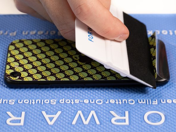 With your application tool slowly slide it along the film until you reach the end of the phone.