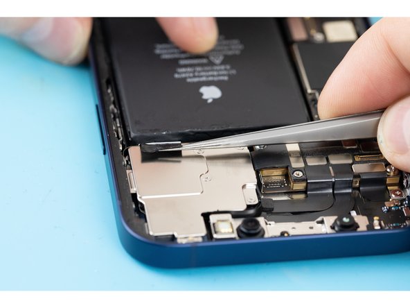 Be careful not to fling the battery from the iPhone as the final adhesive strip comes out.
