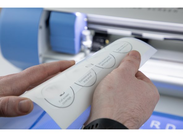 Slowly peel away each side of the film until they meet in the middle and you're able to peel the whole film off.