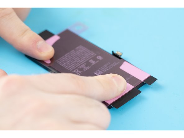 Using your fingers, firmly press the adhesive strips into place.