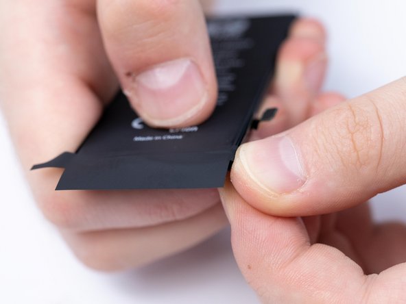 Put the second protective sticker onto the battery making sure to fold the sides.