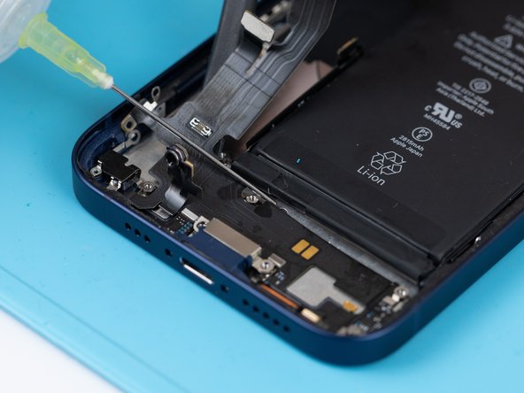 Apply a small amount of IPA to loosen the charge port. This will help you lift it up from the phone case.