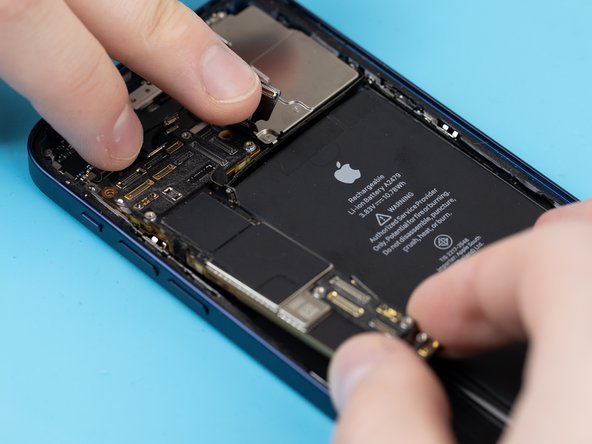 Using your fingers, gently fold back the flex cables at the top of the motherboard. You can now safely remove the motherboard.