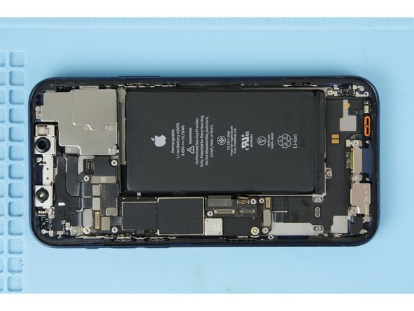 Two of the adhesives are located on the bottom edge of the battery and the other two are located on the top edge. Each individual adhesive has a black pull tab at the end, which is lightly stuck to the edge of the battery.