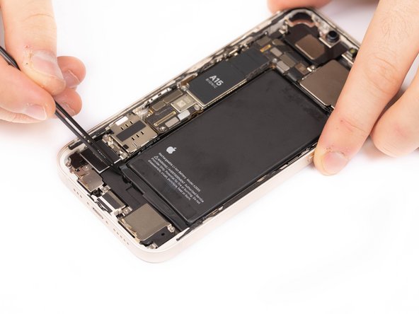 Using tweezers, pull down the first stretch release adhesive pull tab.