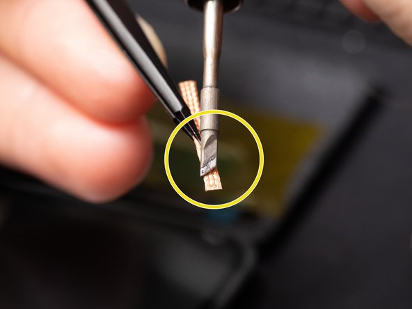 As you can see in this example we are holding the soldering iron on a slant to maximize the heat transfer to the solder wick.