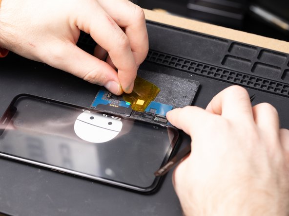 Remove the films and pull tab from the digitizer.