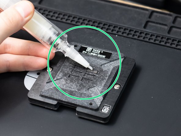 With your chip firmly resting inside the reballing platform,  apply solder flux to the back of the chip.