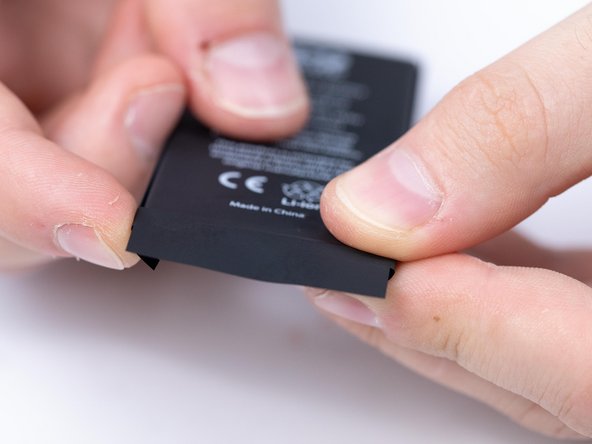 Put the second protective sticker onto the battery making sure to fold the sides.