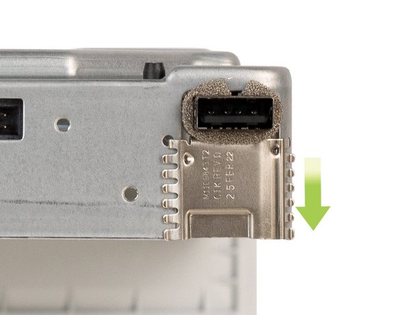 The locking clip is located on the front-left corner of the chassis. To remove the clip, slide it away from the chassis.