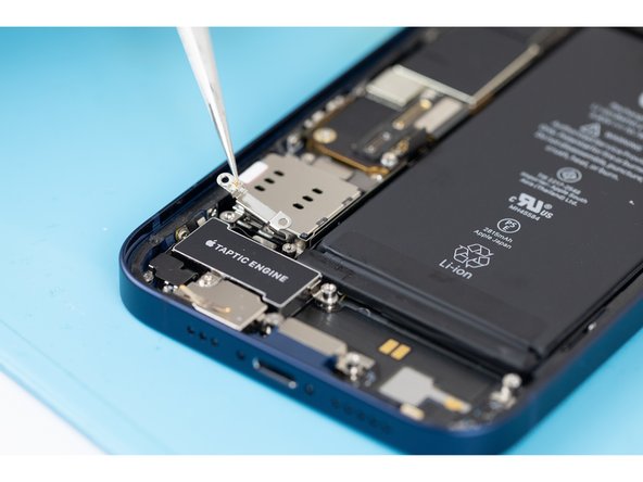 Using tweezers or your fingers, remove the Taptic Engine cable connector bracket.