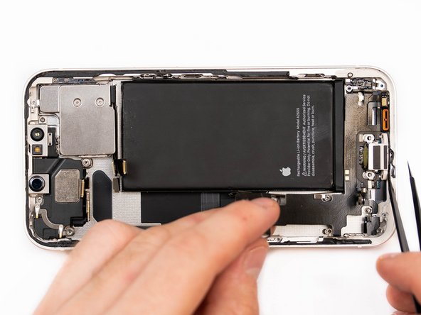 Using a tweezer, slowly pry the charge port away from the phone case.