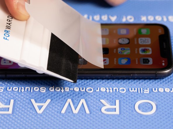 With your application tool slowly slide it along the film until you reach the top of the phone.