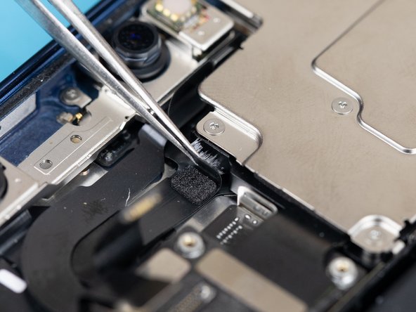 Be cautious when lifting the flex cables as they are glued to the frame. Use a pair of tweezers to slowly lift them away from the frame.