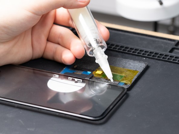 Apply some flux to the digitizer flex. This will help melt the solder joints in the next steps.