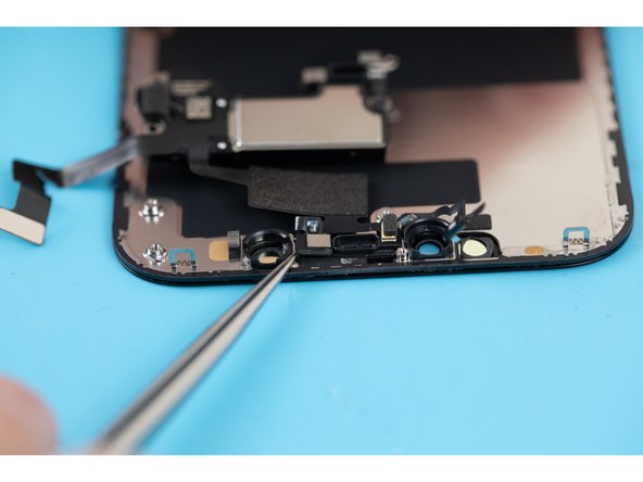 Use a pair of tweezers or a spudger to lift away the proximity sensor and flood illuminator module from its pocket.