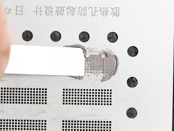 Rub the dried solder paste back and forth on top of the stencil to fill in all of the holes.