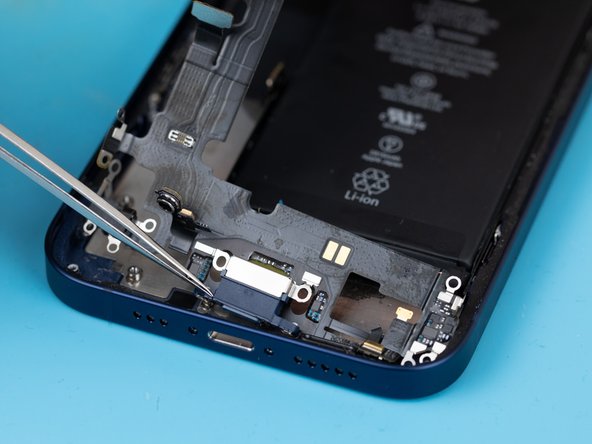 Using a tweezer, slowly pry the charge port away from the phone case.