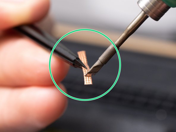 This is an example of how not to hold the soldering iron against the solder wick.