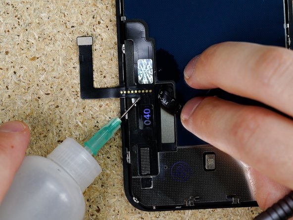 Apply IPA underneath the digitizer Flex and begin prying the flex away from the backplate.