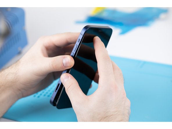 Carefully align the top edge of the display with the top edge of the phones body.