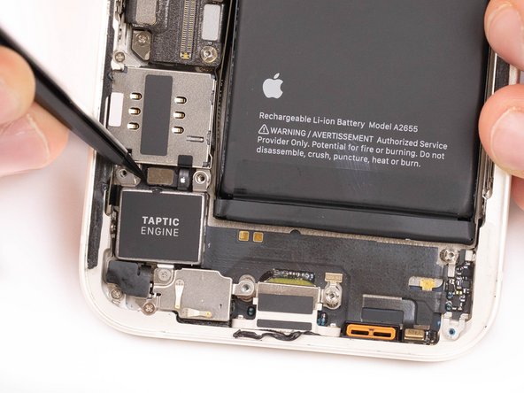 Using the tip of a spudger or tweezers, pry the Taptic Engine flex out of its socket.