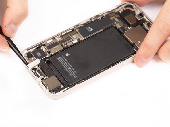 If the adhesive strip does break off, use a tweezers or your fingers to try and retrieve it. It's important not to try and retrieve it by prying underneath the battery.