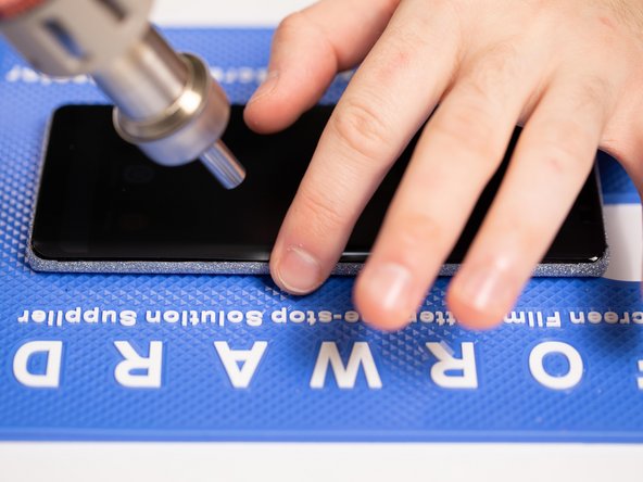 If your phone has curved edges then use a little heat on the edges and fold the film down with you fingers to help it stick to the curved edges.