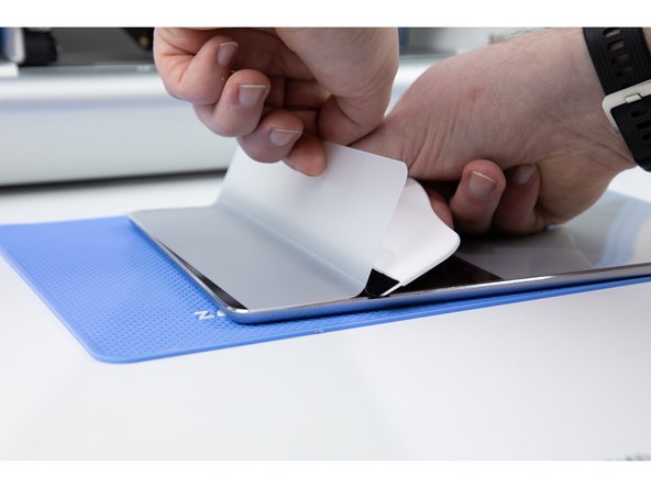 Use an application tool to press the smaller side down onto your iPad. Make sure you are pressing firmly and taking your time with your application tool as this will help avoid air bubbles.